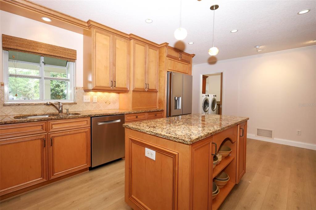 102 Pineview Court Altamonte Springs, FL 32714 - Photo 14 of 59 a kitchen with stainless steel appliances granite countertop a sink a stove and a wooden floors