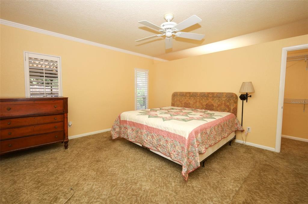 102 Pineview Court Altamonte Springs, FL 32714 - Photo 20 of 59 a bedroom with a bed and a chandelier