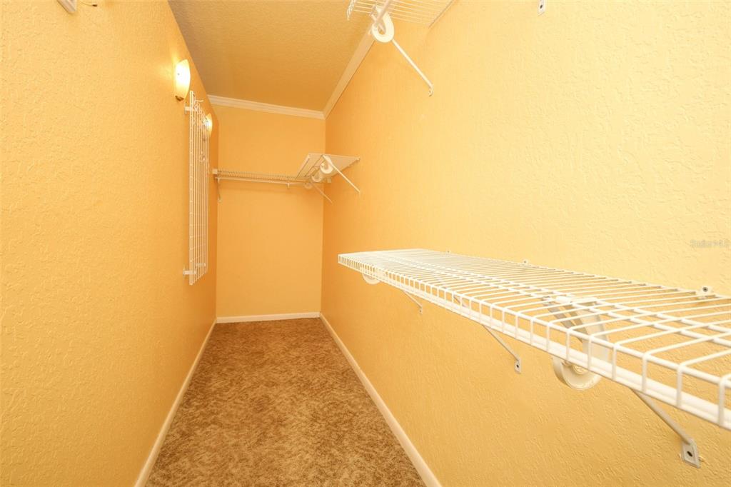 102 Pineview Court Altamonte Springs, FL 32714 - Photo 21 of 59 a view of walk in closet with wooden floor
