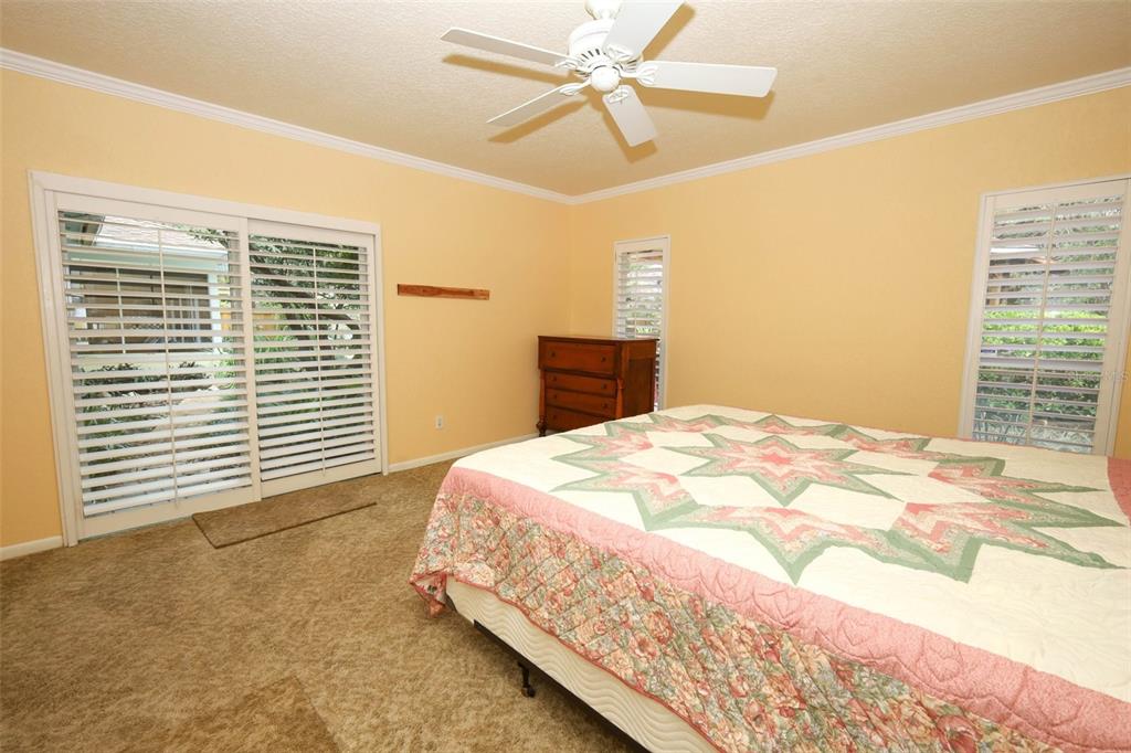 102 Pineview Court Altamonte Springs, FL 32714 - Photo 22 of 59 a bedroom with a bed and a chandelier