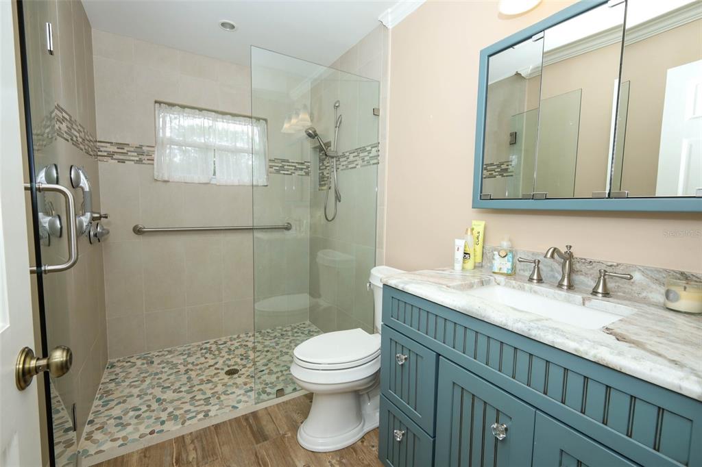 102 Pineview Court Altamonte Springs, FL 32714 - Photo 31 of 59 a bathroom with a granite countertop sink toilet a mirror and shower