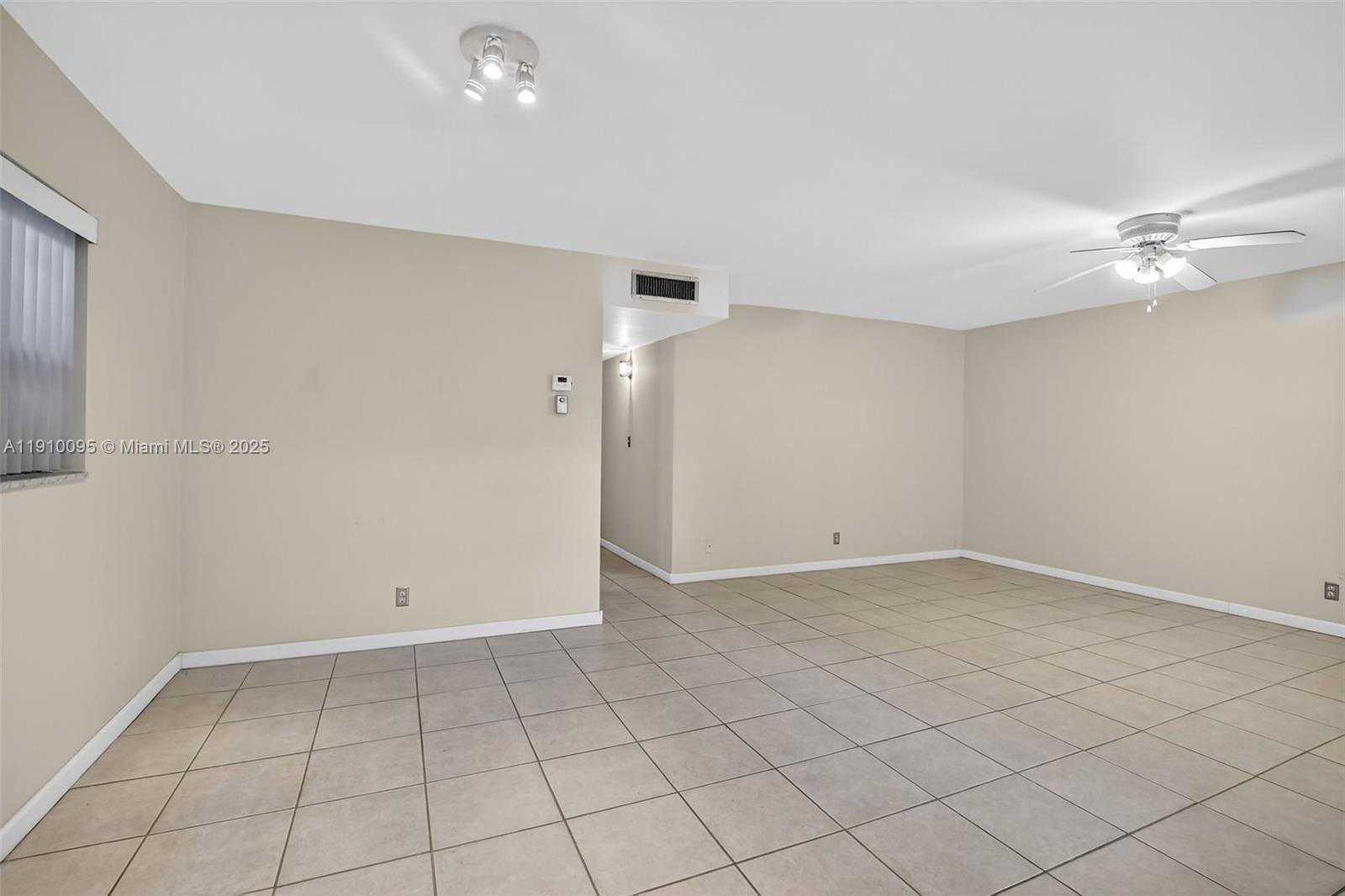 5300 Washington Street, Unit T218 Hollywood, FL 33021 - Photo 15 of 36 an empty room with a ceiling fan and carpet