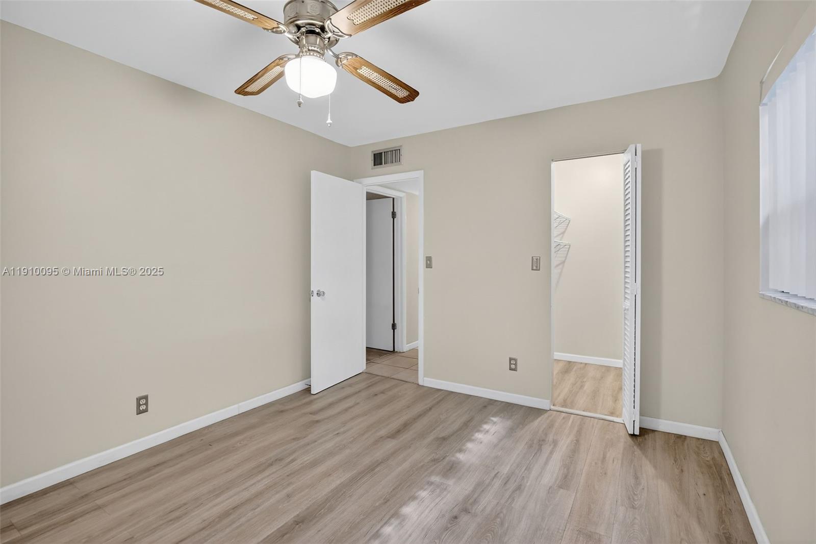 5300 Washington Street, Unit T218 Hollywood, FL 33021 - Photo 25 of 36 an empty room with wooden floor a ceiling fan and closet