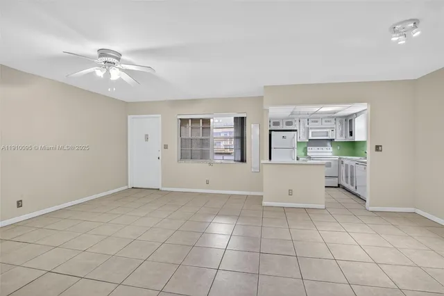 a kitchen with a refrigerator sink and cabinets