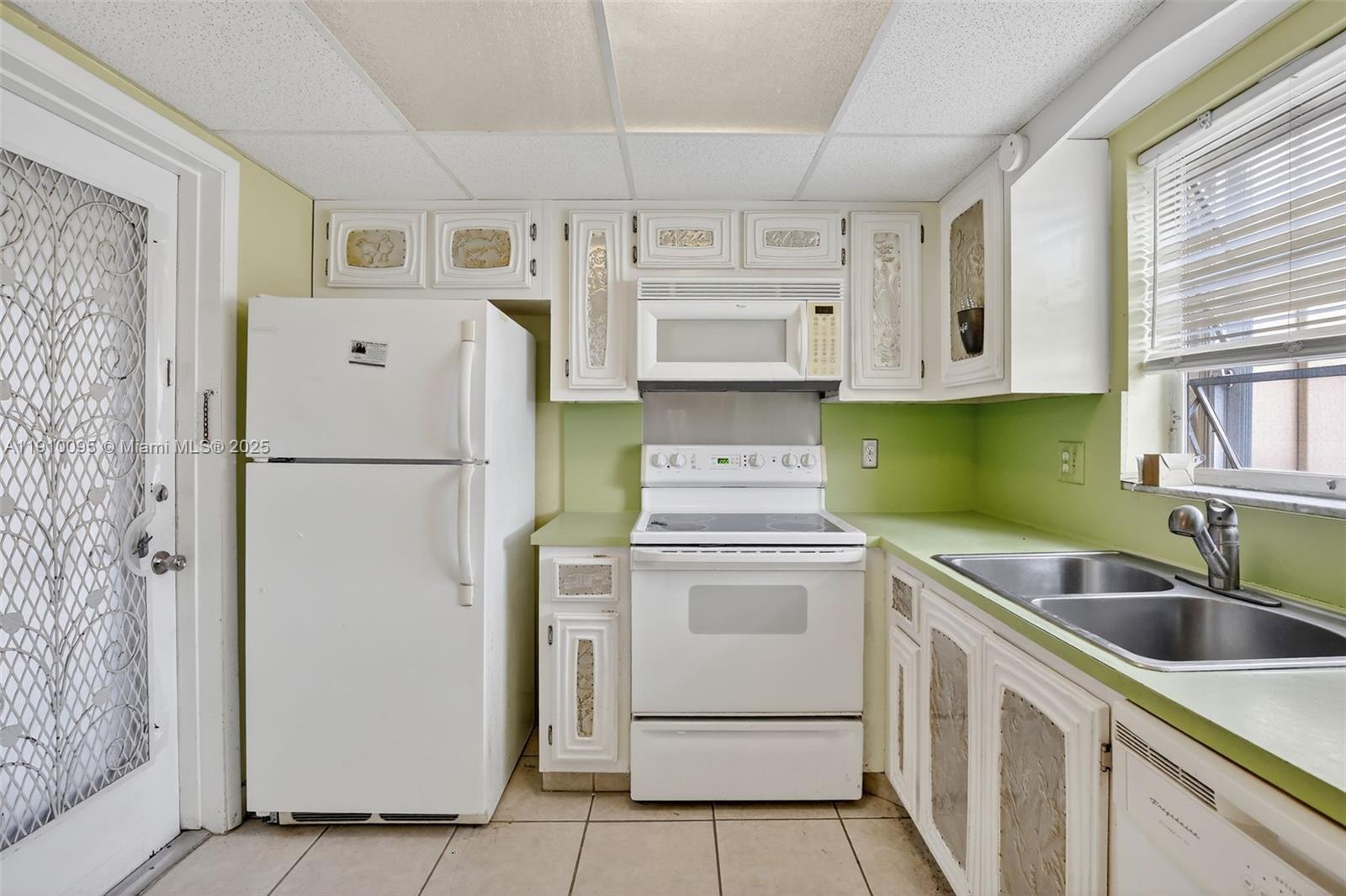 5300 Washington Street, Unit T218 Hollywood, FL 33021 - Photo 8 of 36 a kitchen with a refrigerator sink and cabinets