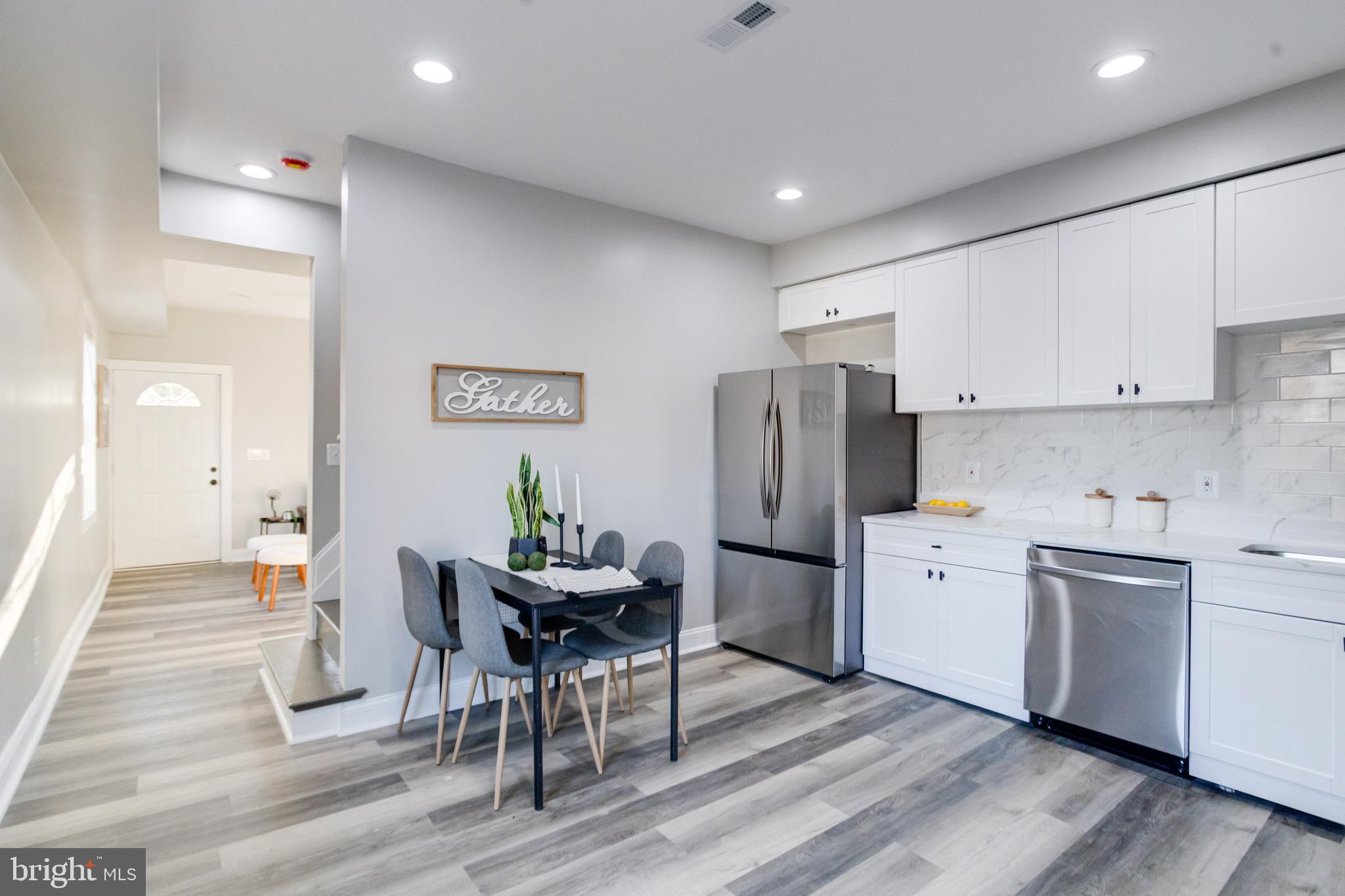 1534 Homestead Street Baltimore, MD 21218 - Photo 11 of 48 a kitchen with stainless steel appliances kitchen island granite countertop a refrigerator and cabinets