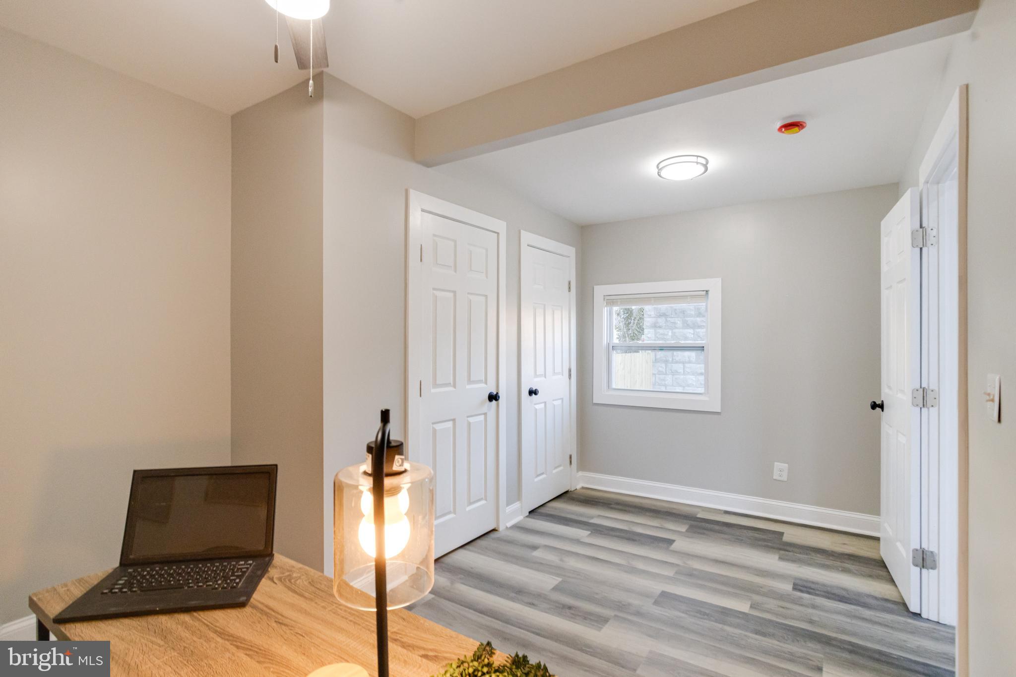 1534 Homestead Street Baltimore, MD 21218 - Photo 19 of 48 a view of an empty room with wooden floor and a window