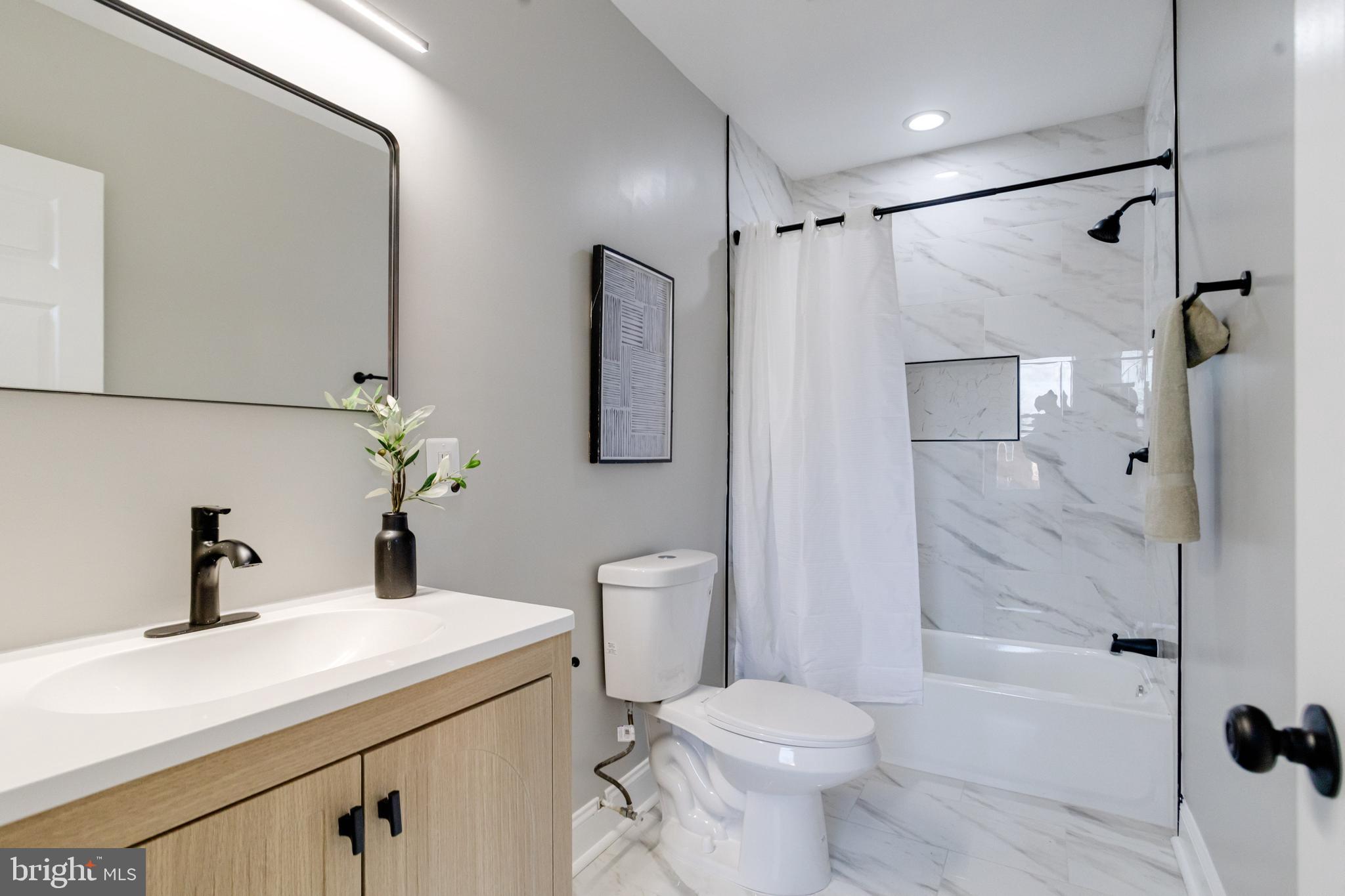 1534 Homestead Street Baltimore, MD 21218 - Photo 20 of 48 a bathroom with a sink toilet and shower