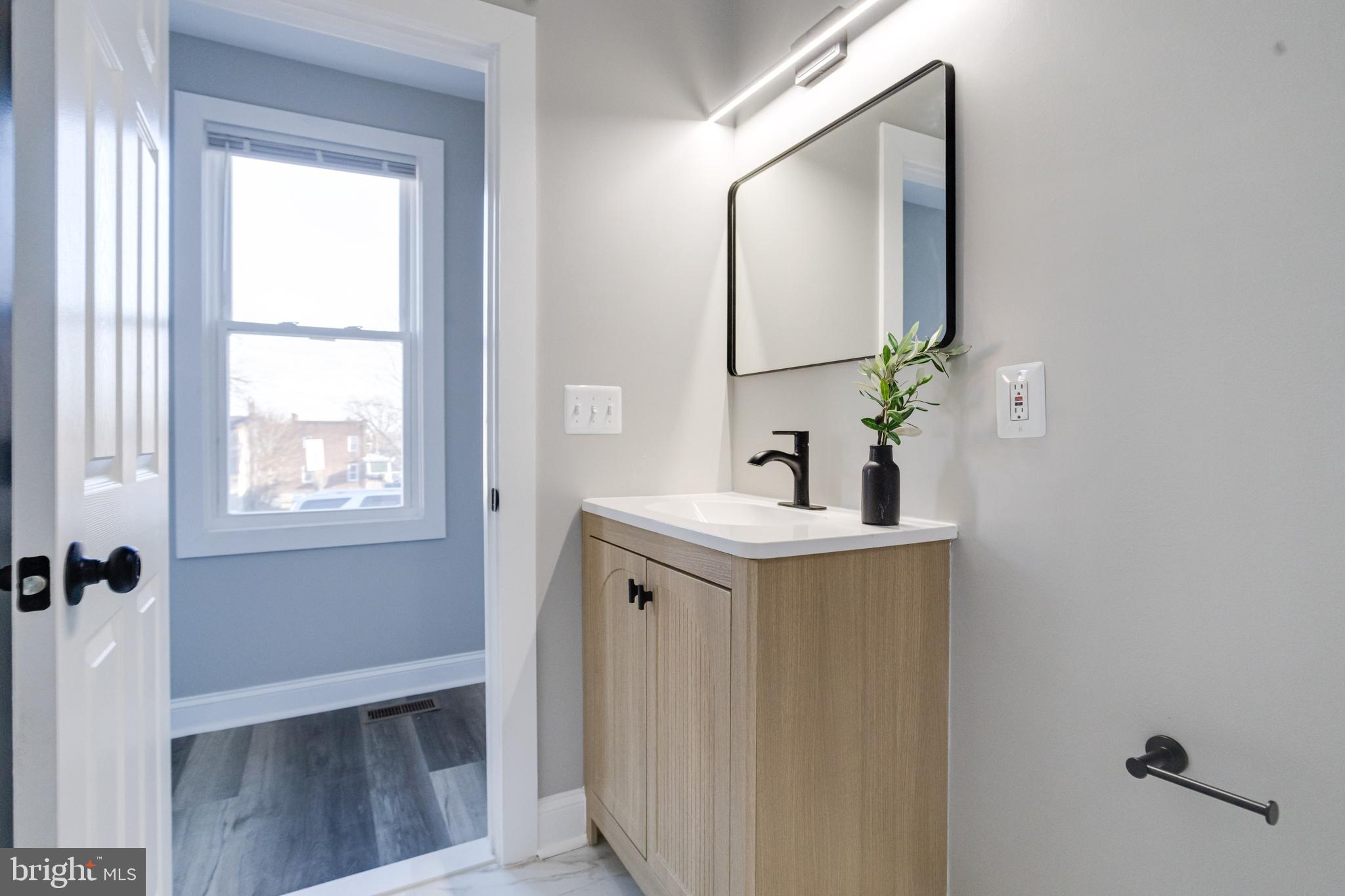 1534 Homestead Street Baltimore, MD 21218 - Photo 22 of 48 a bathroom with a sink and a mirror