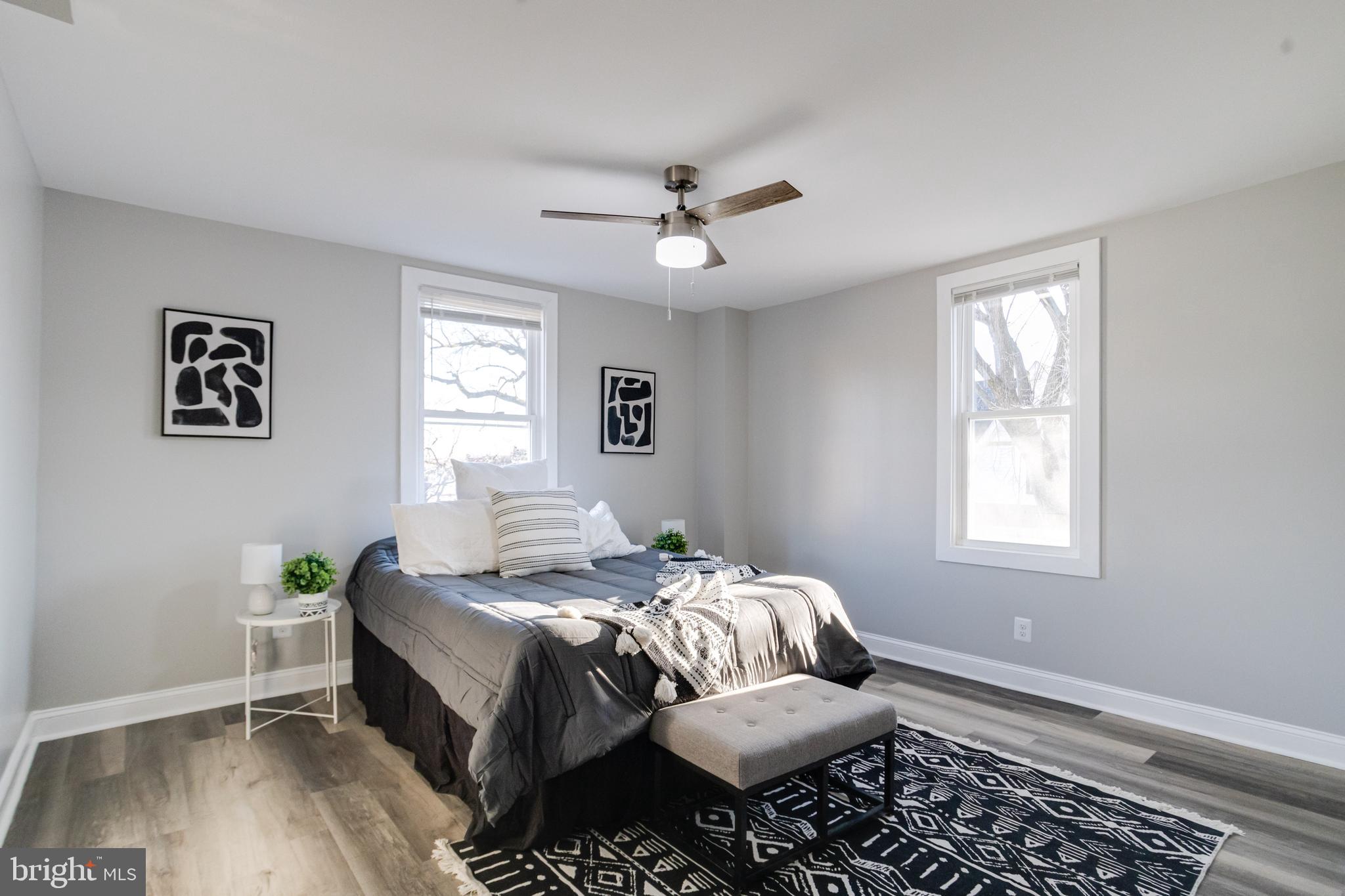 1534 Homestead Street Baltimore, MD 21218 - Photo 23 of 48 a bedroom with a bed and wooden floor