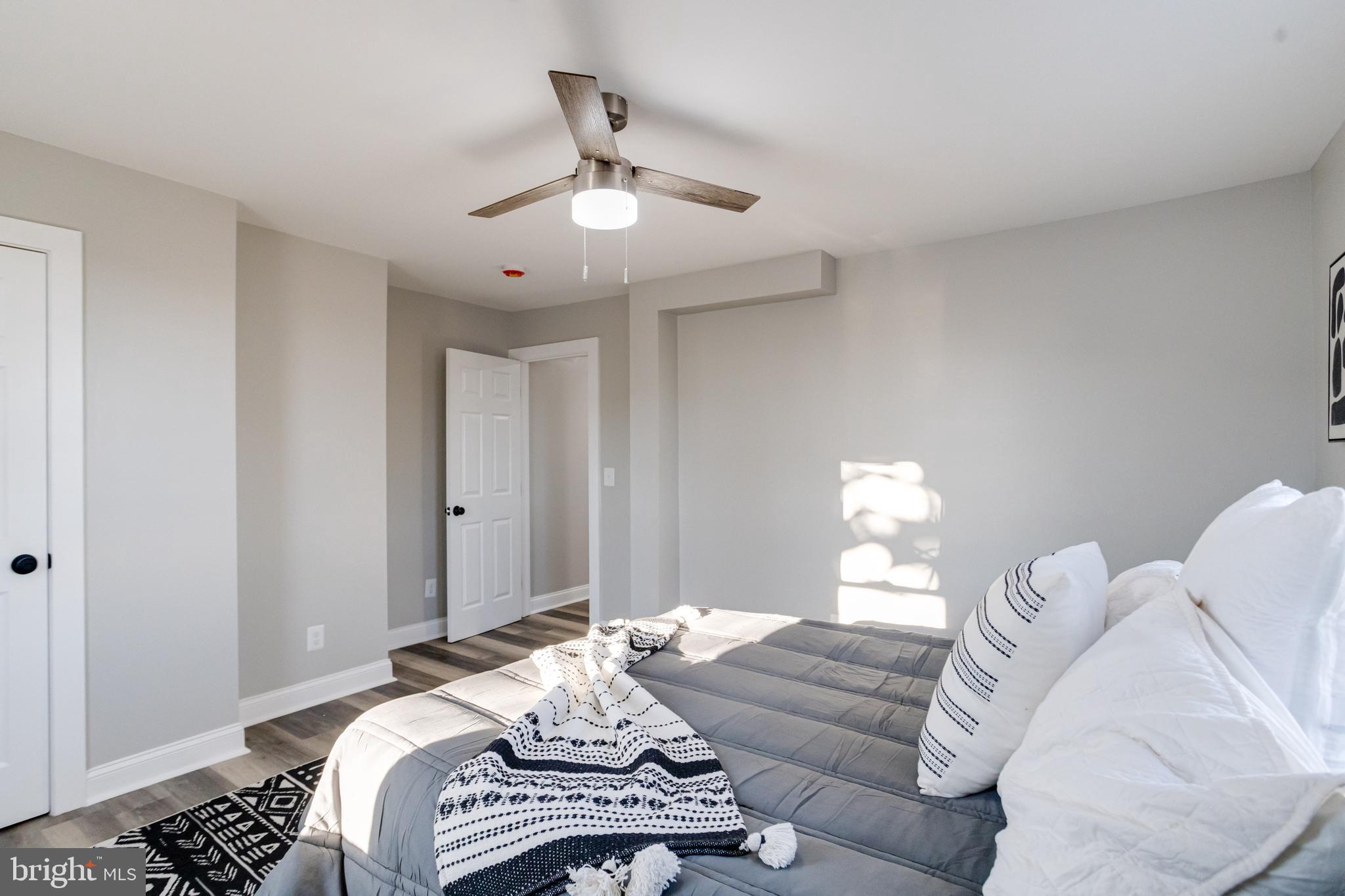 1534 Homestead Street Baltimore, MD 21218 - Photo 27 of 48 a bedroom with a bed and a chandelier