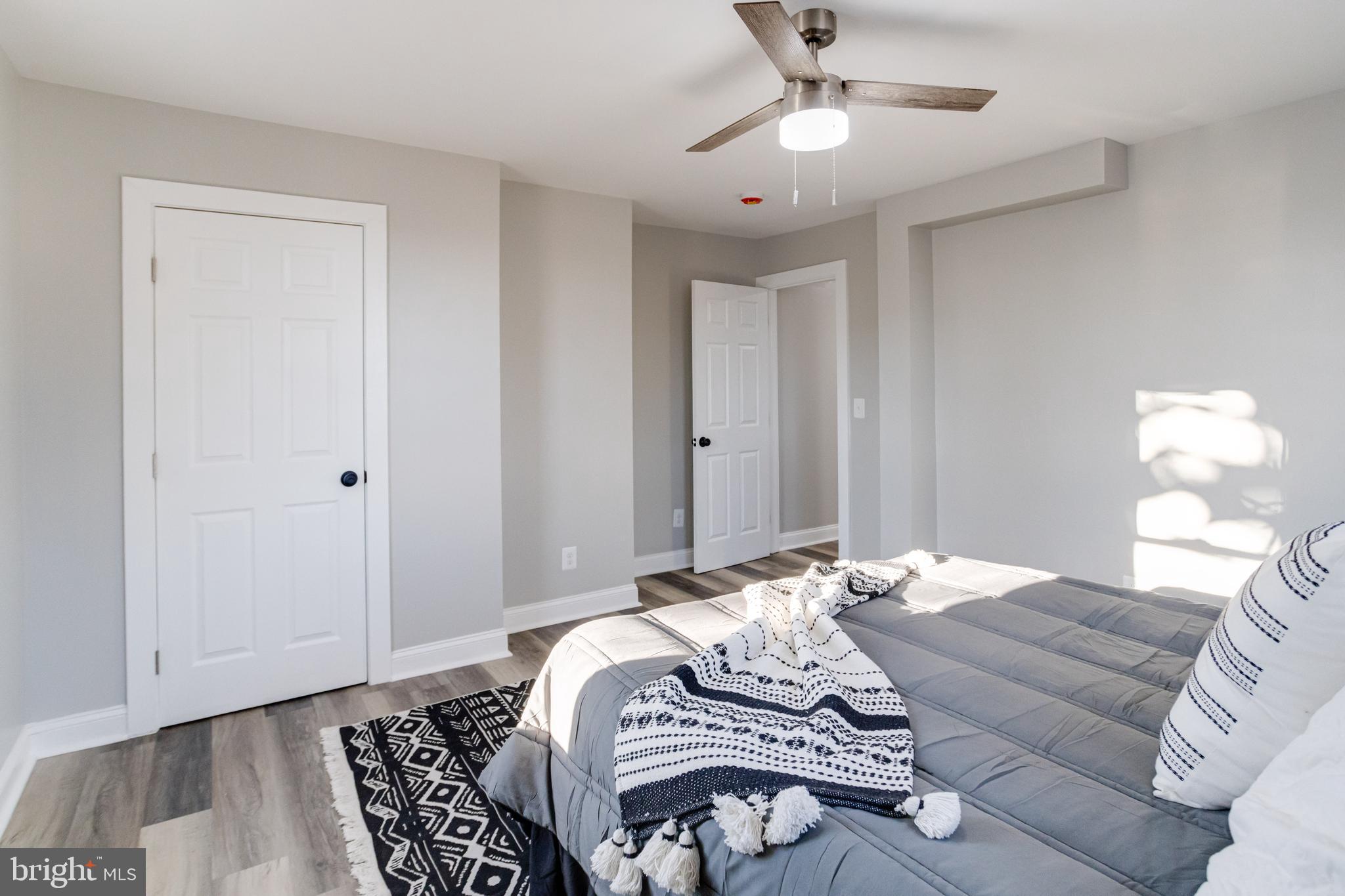 1534 Homestead Street Baltimore, MD 21218 - Photo 28 of 48 a bedroom with bed and wooden floor