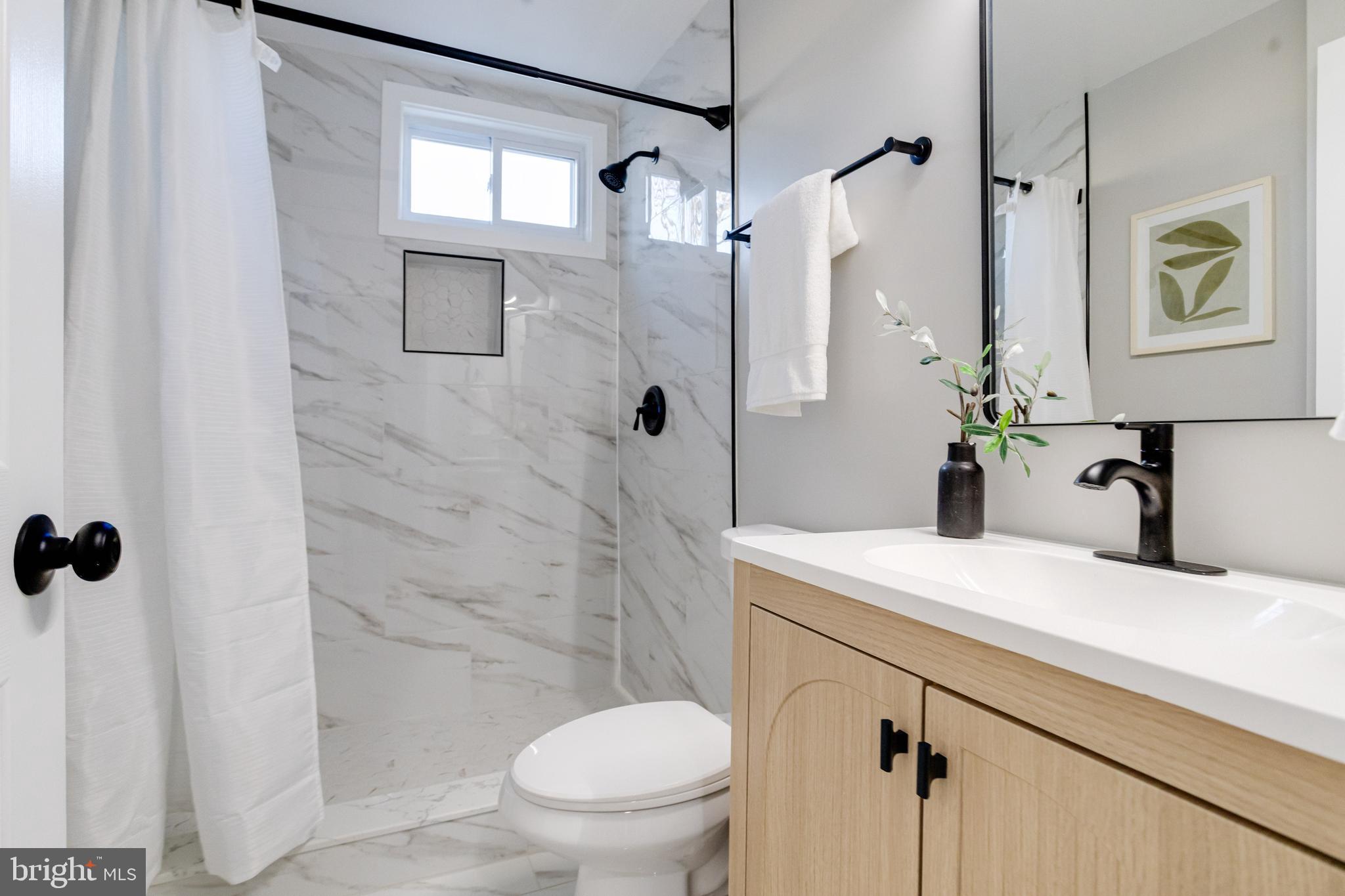 1534 Homestead Street Baltimore, MD 21218 - Photo 29 of 48 a bathroom with a sink toilet and shower