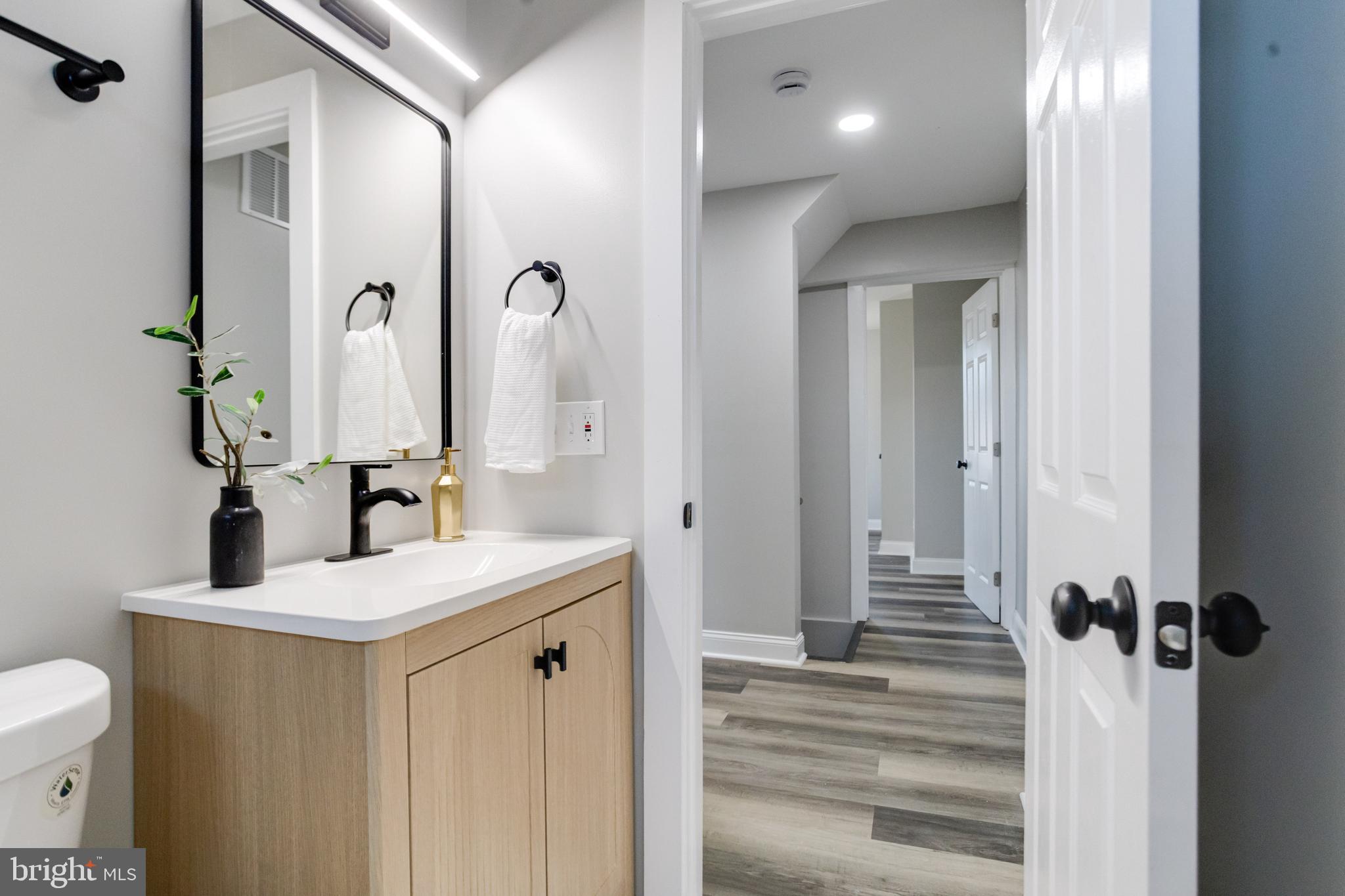 1534 Homestead Street Baltimore, MD 21218 - Photo 31 of 48 a bathroom with a sink a toilet and shower