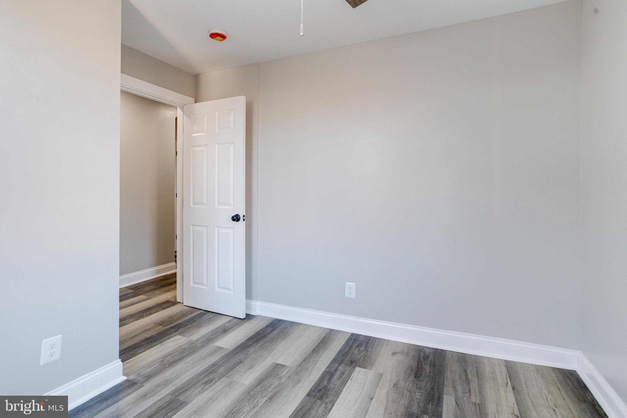 1534 Homestead Street Baltimore, MD 21218 - Photo 34 of 48 a view of an empty room with wooden floor