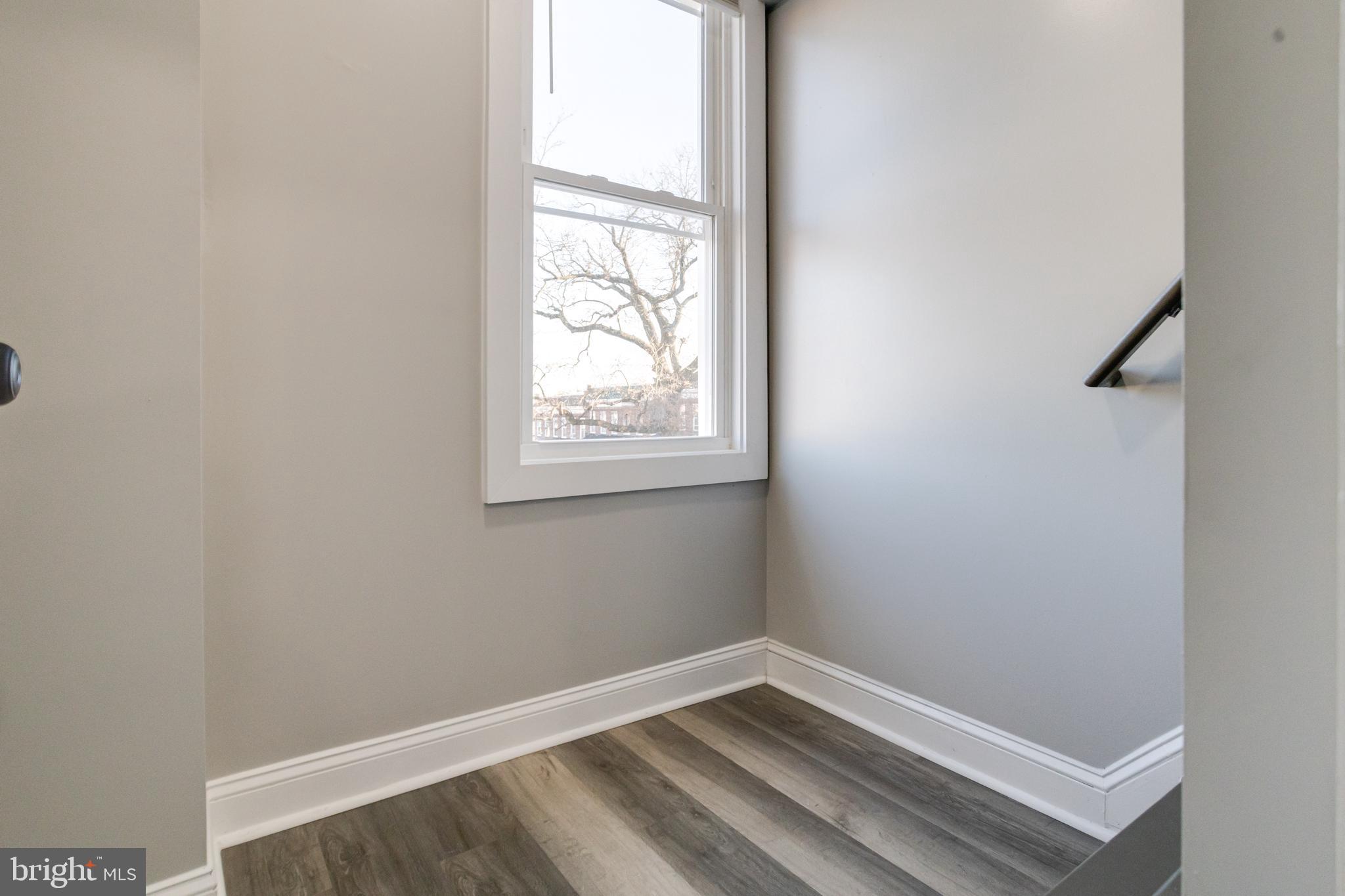 1534 Homestead Street Baltimore, MD 21218 - Photo 35 of 48 a view of an empty room with wooden floor and a window