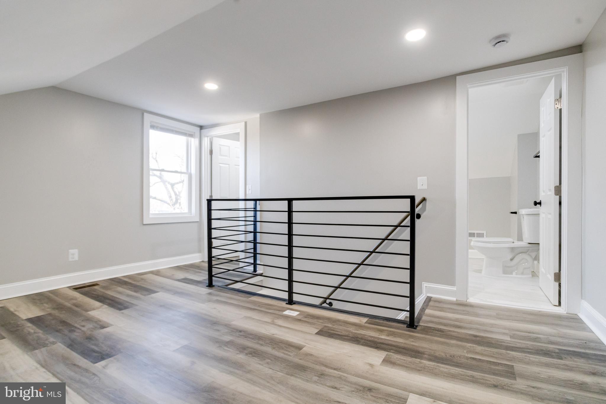 1534 Homestead Street Baltimore, MD 21218 - Photo 41 of 48 an empty room with wooden floor and windows