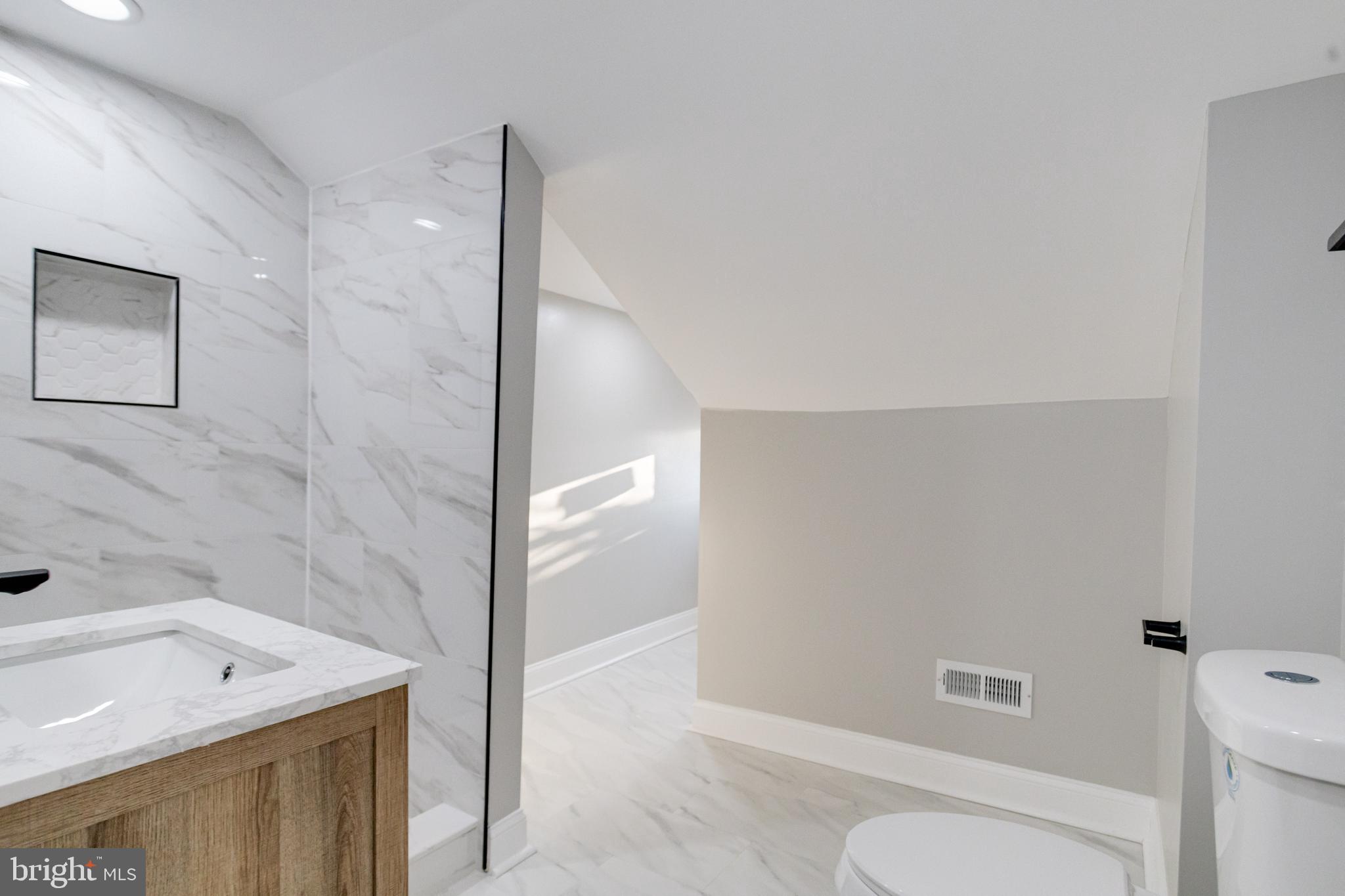 1534 Homestead Street Baltimore, MD 21218 - Photo 42 of 48 a bathroom with a sink a toilet and shower