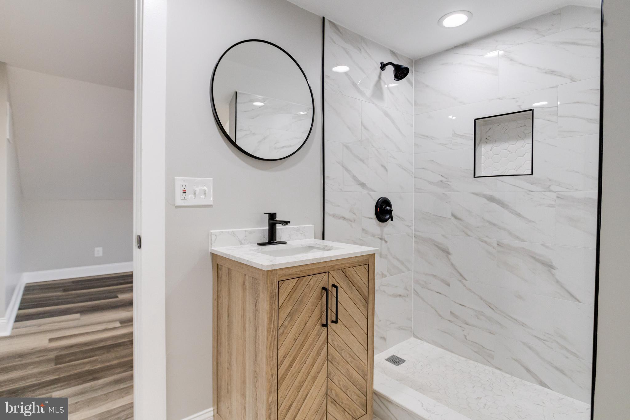 1534 Homestead Street Baltimore, MD 21218 - Photo 43 of 48 a bathroom with a sink a toilet and a mirror
