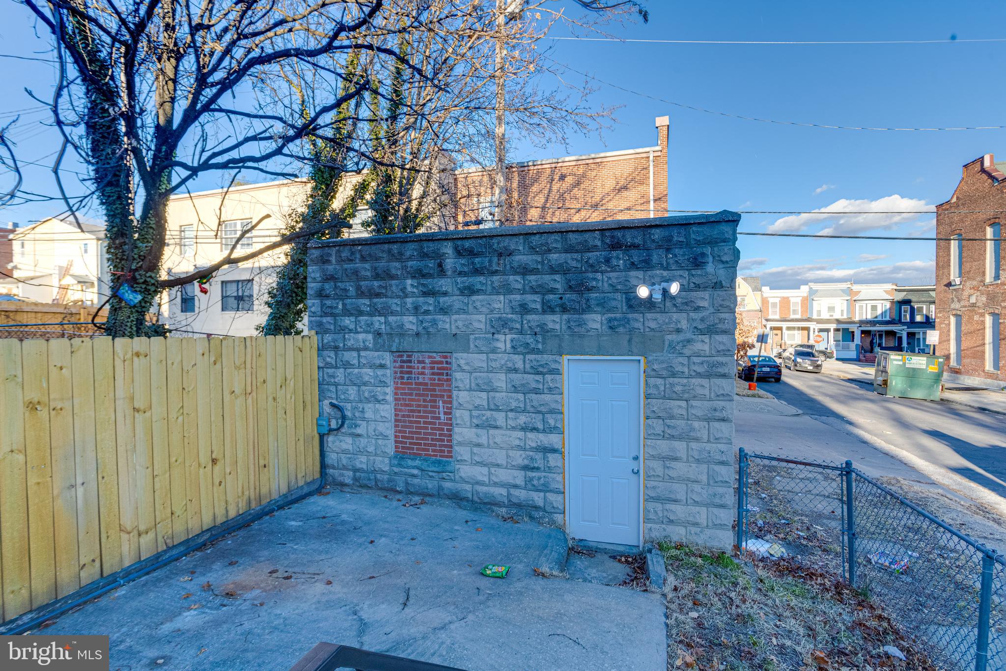1534 Homestead Street Baltimore, MD 21218 - Photo 45 of 48 a brick building with a bench and trees