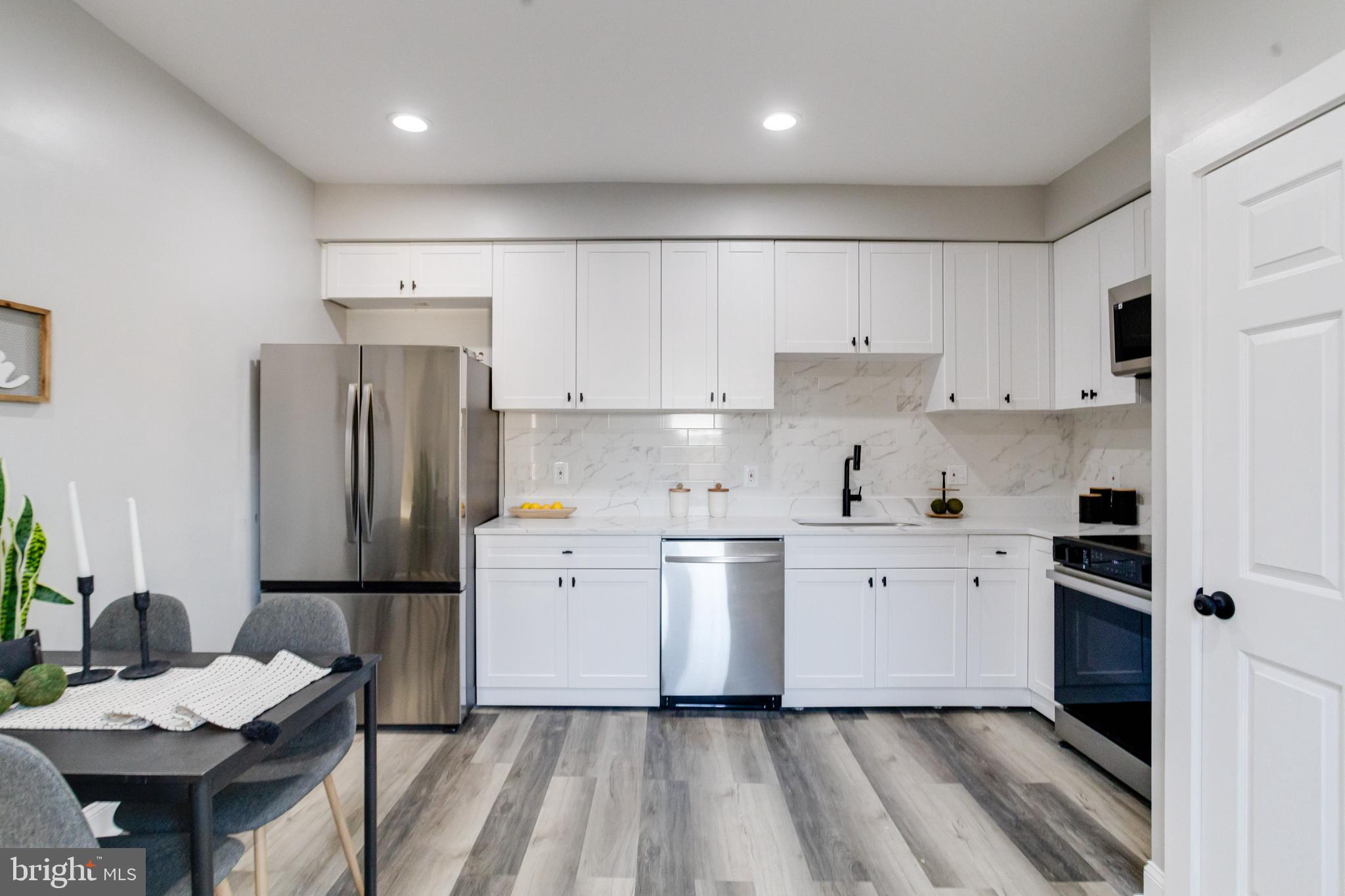 1534 Homestead Street Baltimore, MD 21218 - Photo 10 of 48 a kitchen with a refrigerator a sink and a stove