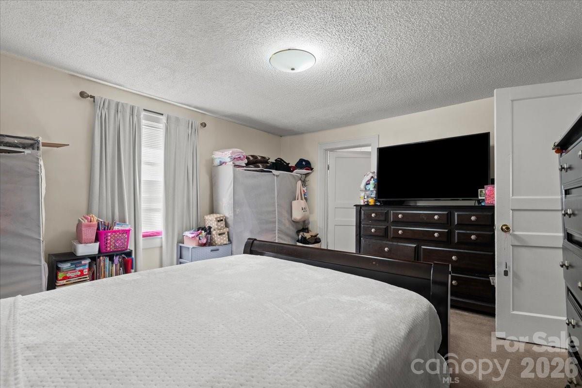 501 Church Street Cheraw, SC 29520 - Photo 42 of 48 a bedroom with a bed and a flat screen tv