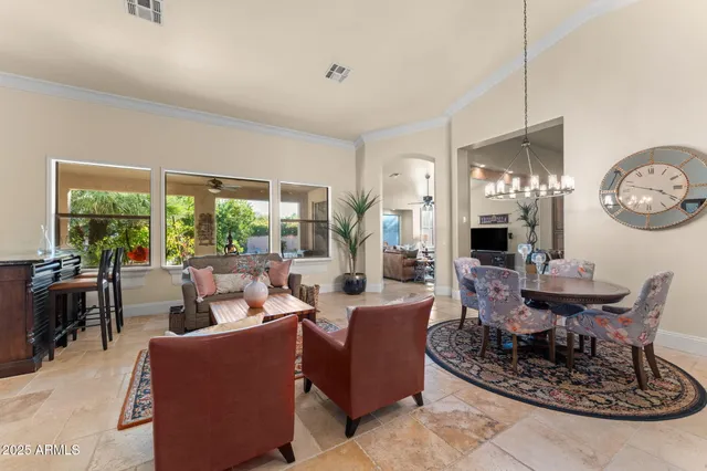 a dining room with furniture a clock and a large mirror