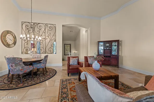 a living room with furniture a large window and a dining table