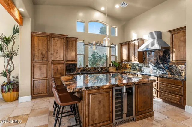 a kitchen with stainless steel appliances granite countertop a stove and a refrigerator