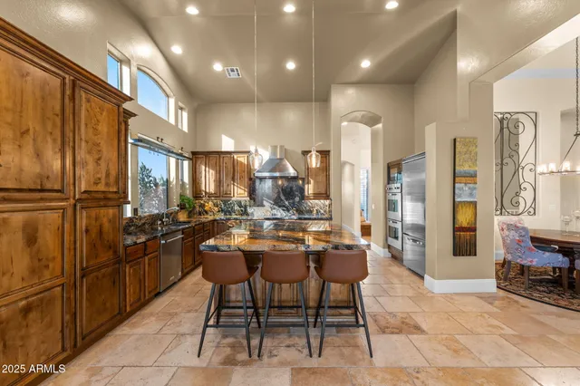 a large kitchen with a table and chairs