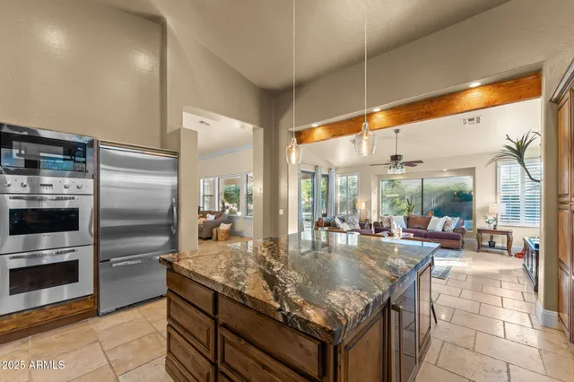 a kitchen with granite countertop a stove and refrigerator