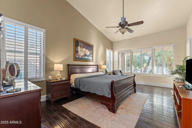 a bedroom with a large bed and a chandelier