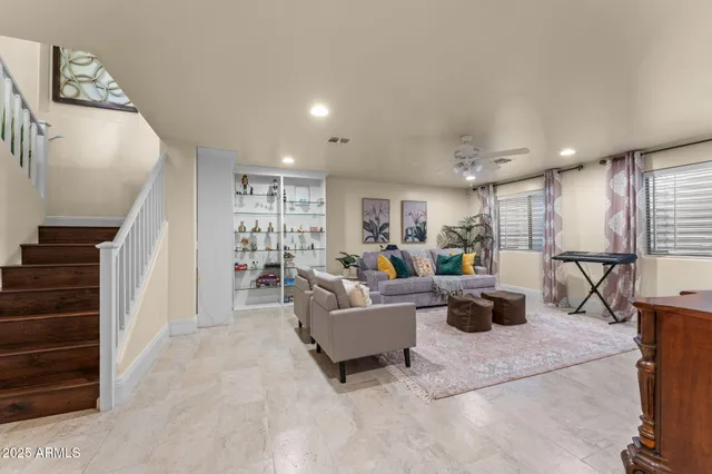 a living room with furniture and a wooden floor