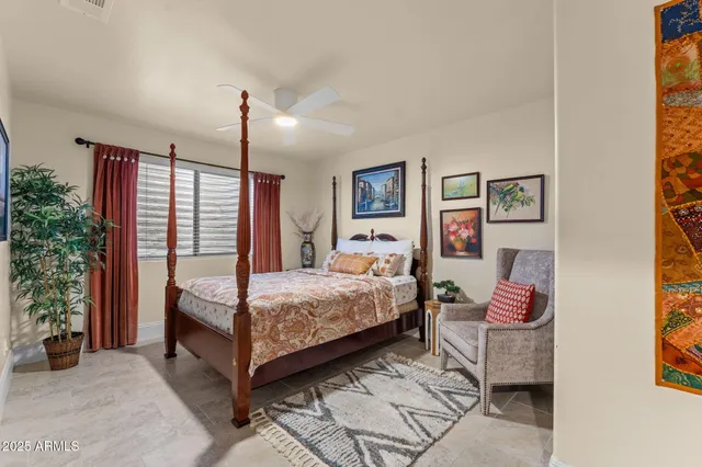 a bedroom with a bed and a potted plant
