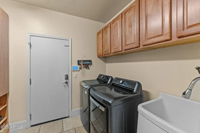 a utility room with sink dryer and washer