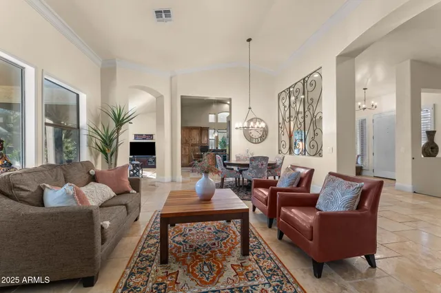 a living room with furniture and a chandelier