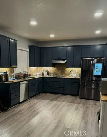 a kitchen with granite countertop wooden cabinets and stainless steel appliances