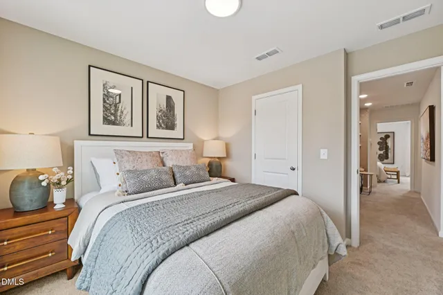 a living room with furniture and a painting on the wall