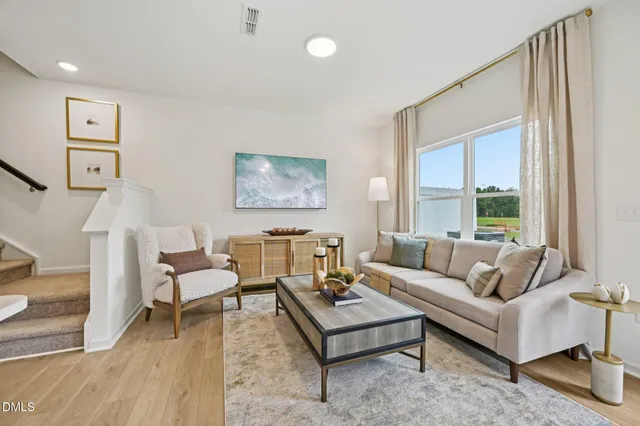 a kitchen with a table chairs refrigerator and cabinets