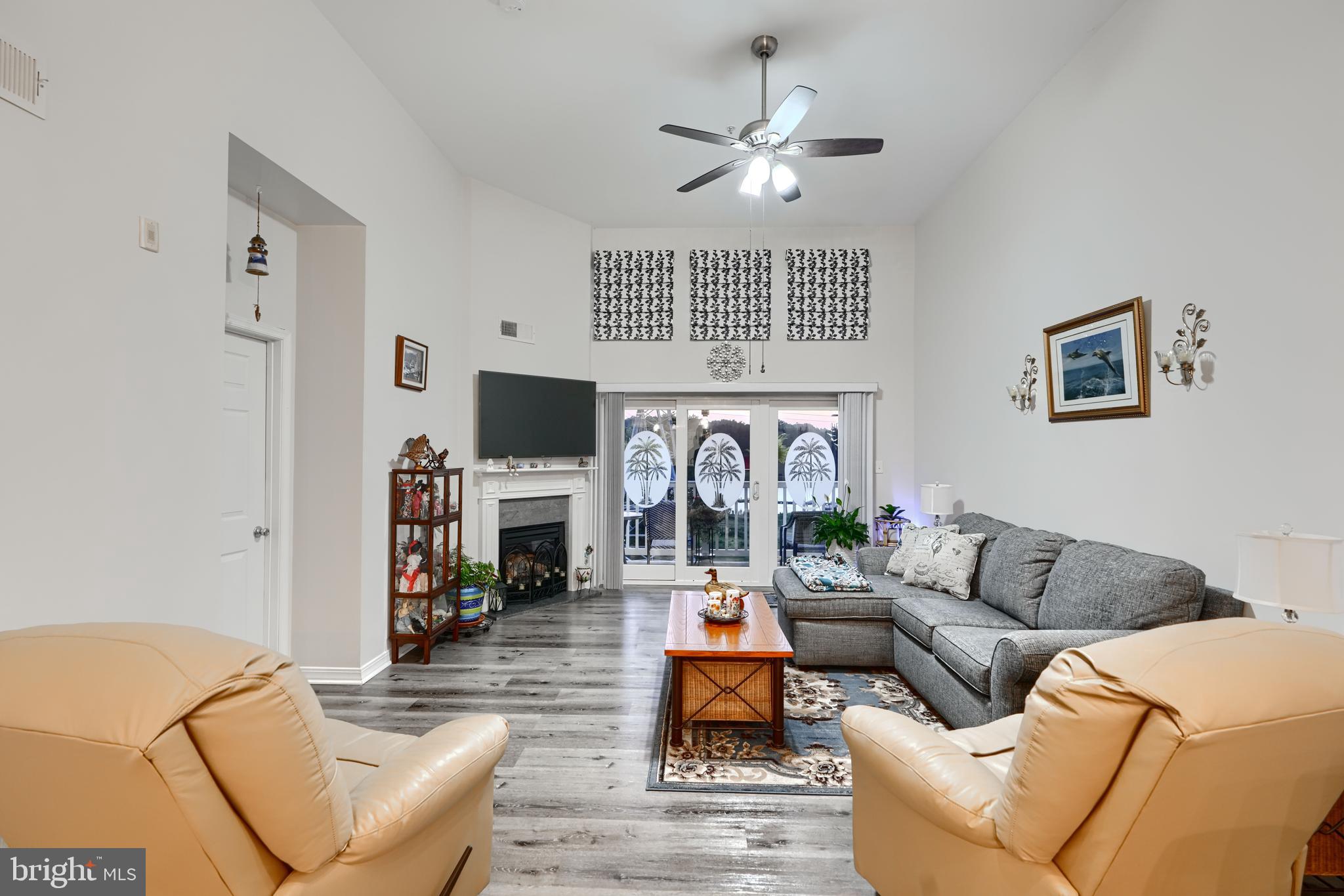 231 Roundhouse Drive, Unit 3E Perryville, MD 21903 - Photo 11 of 38 a living room with fireplace furniture and a flat screen tv