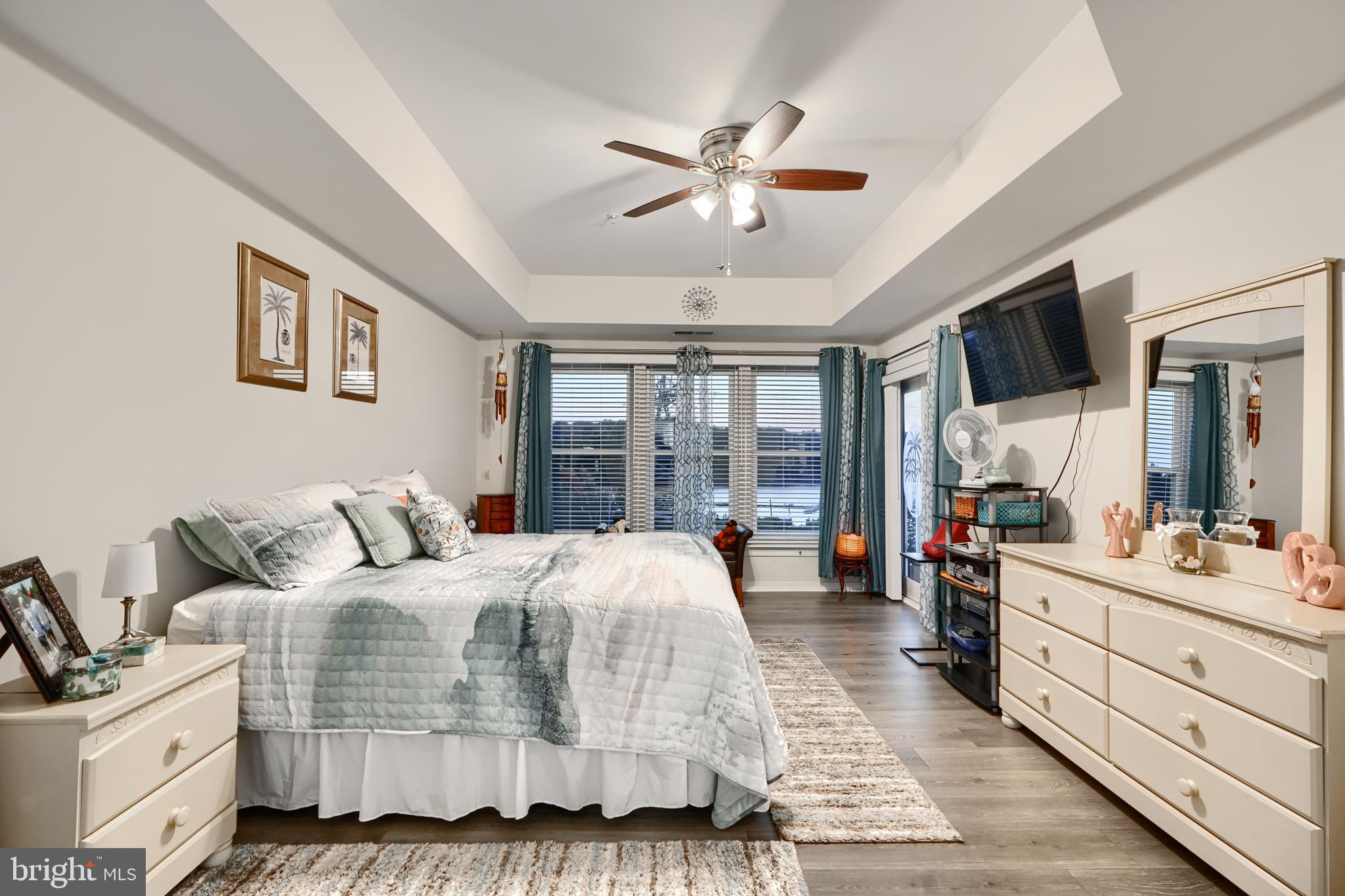 231 Roundhouse Drive, Unit 3E Perryville, MD 21903 - Photo 16 of 38 a bedroom with a large bed and a flat tv screen