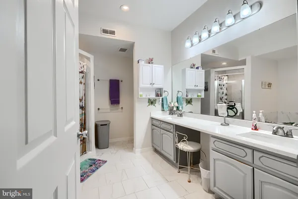 a spacious bathroom with a double vanity sink mirror and toilet