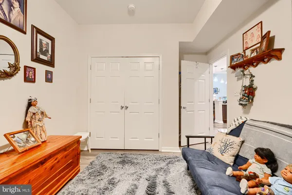 a bedroom with furniture and wooden floor