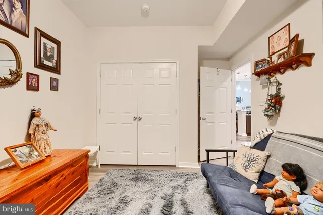 a bedroom with furniture and wooden floor