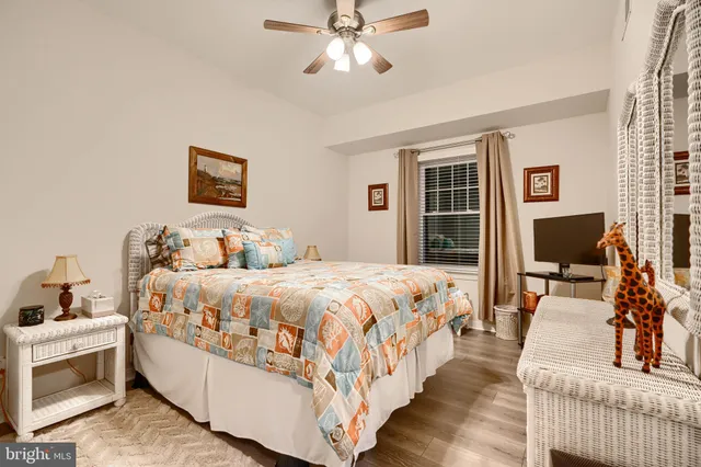 a bedroom with bed and a flat screen tv