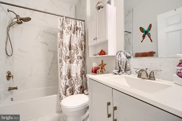 a bathroom with a sink a toilet and a bathtub