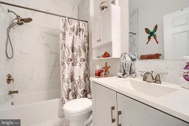 a bathroom with a sink a toilet and a bathtub