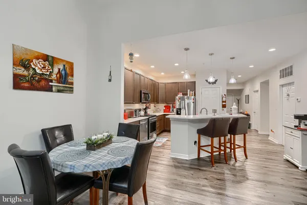 a view of a dining room with furniture and wooden floor
