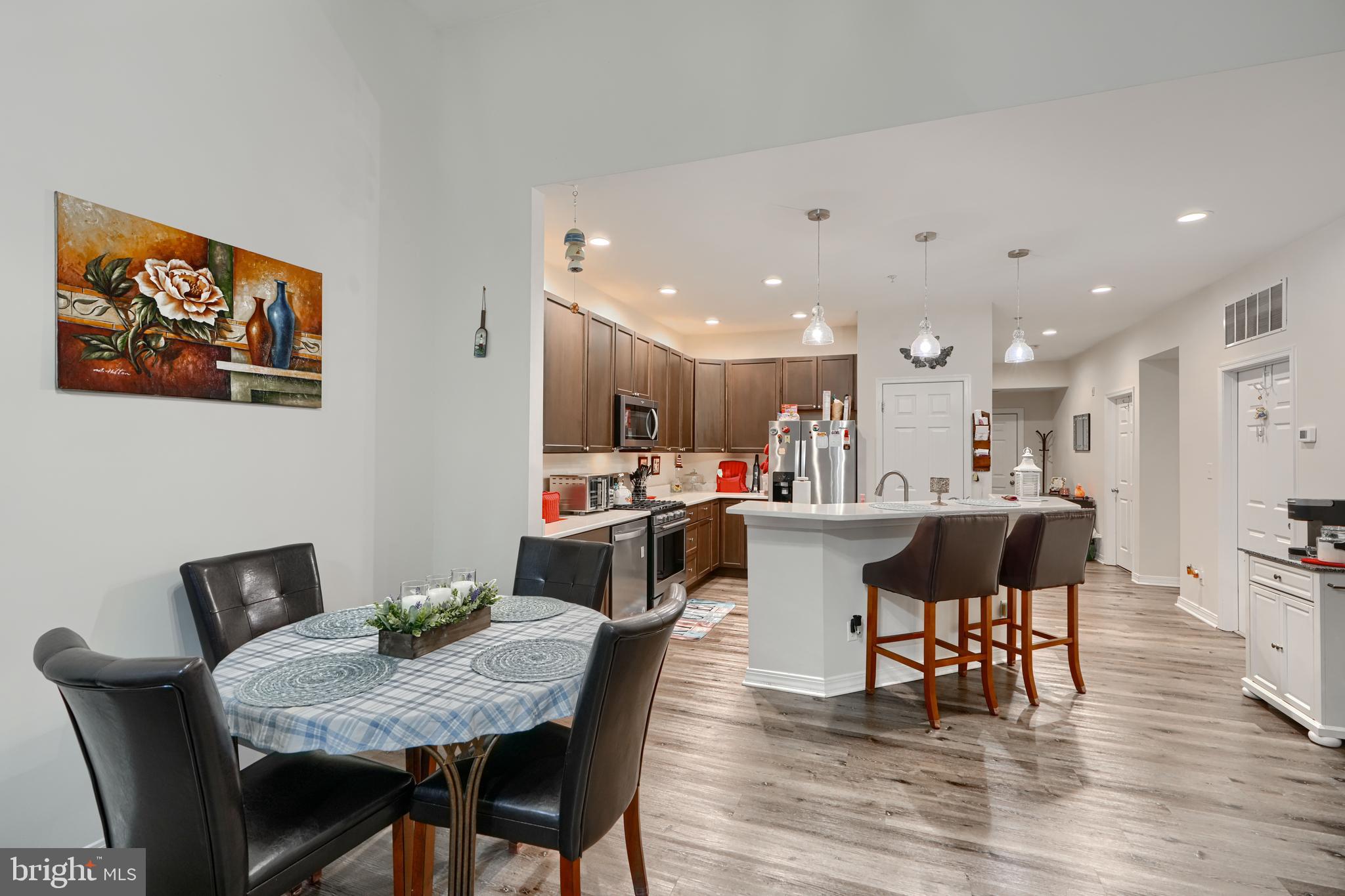 231 Roundhouse Drive, Unit 3E Perryville, MD 21903 - Photo 10 of 38 a view of a dining room with furniture and wooden floor