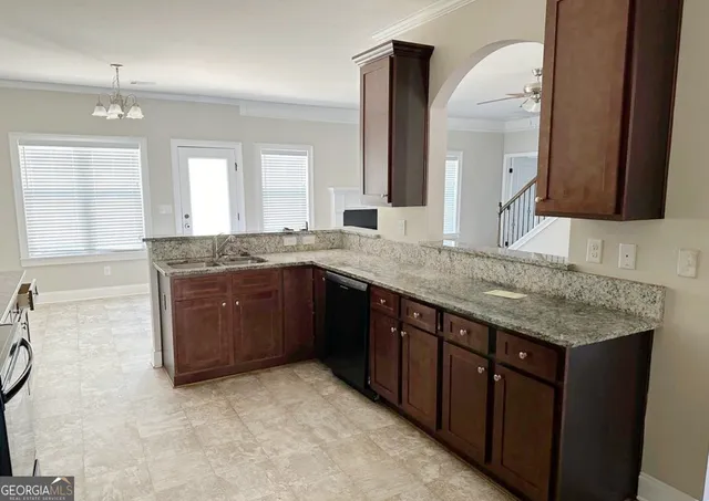 a bathroom with a granite countertop double vanity sink and mirror